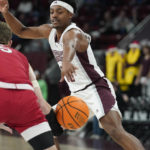 
              Mississippi State guard Eric Reed Jr. (11) reaches for the ball against Nicholls State guard Pierce Spencer (5) during the first half of an NCAA college basketball game, in Starkville, Miss., Saturday, Dec. 17, 2022. (AP Photo/Rogelio V. Solis)
            