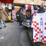 
              People walk among shops selling Croatian football jerseys and various fan props prior to the Qatar World Cup semi-final match between Croatia and Argentina, in Zagreb, Croatia, Tuesday, Dec. 13, 2022. (AP Photo/Armin Durgut)
            