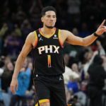 
              Phoenix Suns guard Devin Booker reacts to a basket during the second half of an NBA basketball game against the New Orleans Pelicans, Saturday, Dec. 17, 2022, in Phoenix. The Suns defeated the Pelicans 118-114. (AP Photo/Matt York)
            