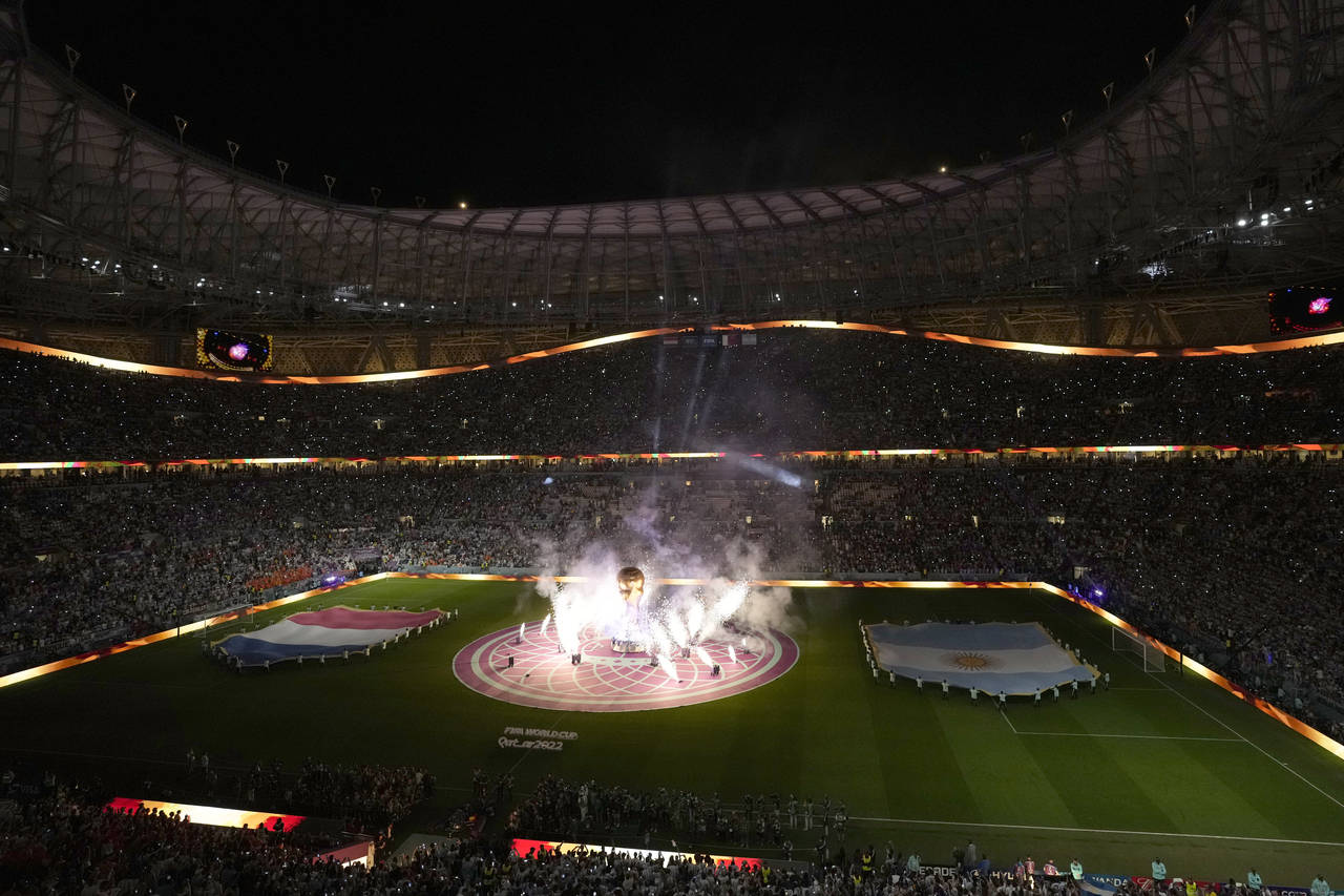 Fireworks go off around a mock of a World Cup trophy prior to the start of the World Cup quarterfin...