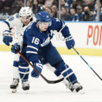 
              Toronto Maple Leafs' Mitchell Marner takes the puck away from Tampa Bay Lightning's Brandon Hagel during the second period of an NHL hockey game, Tuesday, Dec. 20, 2022 in Toronto. (Chris Young/The Canadian Press via AP)
            