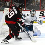 
              San Jose Sharks goaltender Kaapo Kahkonen (36) watches the puck in front of Ottawa Senators right wing Drake Batherson (19) during the second period of an NHL hockey game Saturday, Dec. 3, 2022, in Ottawa, Ontario. (Justin Tang/The Canadian Press via AP)
            