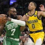 
              Boston Celtics guard Jaylen Brown (7) drives to the basket against Indiana Pacers guard Tyrese Haliburton during the first half of an NBA basketball game, Wednesday, Dec. 21, 2022, in Boston. (AP Photo/Charles Krupa)
            
