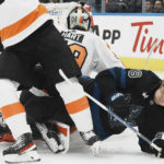 
              Toronto Maple Leafs right wing William Nylander (88) falls to the ice near Philadelphia Flyers goaltender Carter Hart (79) during the second period of an NHL hockey game, Thursday, Dec. 22, 2022 in Toronto. (Chris Young/The Canadian Press via AP)
            