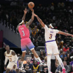 
              Washington Wizards guard Bradley Beal, center left, shoots to score against Los Angeles Lakers forward Anthony Davis, right, during the first half of an NBA basketball game, Sunday, Dec. 4, 2022, in Washington. (AP Photo/Jess Rapfogel)
            