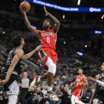
              New Orleans Pelicans' Naji Marshall (8) shoots against San Antonio Spurs' Devin Vassell (24) during the second half of an NBA basketball game, Friday, Dec. 2, 2022, in San Antonio. (AP Photo/Darren Abate)
            