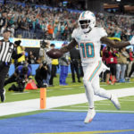 
              Miami Dolphins wide receiver Tyreek Hill (10) scores a touchdown after recovering a fumble during the first half of an NFL football game against the Los Angeles Chargers Sunday, Dec. 11, 2022, in Inglewood, Calif. (AP Photo/Jae C. Hong)
            
