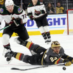
              Vegas Golden Knights defenseman Alec Martinez (23) reaches for the puck after falling to the ice in front of Arizona Coyotes center Travis Boyd (72) during the first period of an NHL hockey game Wednesday, Dec. 21, 2022, in Las Vegas. (AP Photo/Chase Stevens)
            