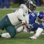 
              Philadelphia Eagles defensive end Brandon Graham (55) forces a fumble by New York Giants quarterback Tyrod Taylor (2) during the fourth quarter of an NFL football game, Sunday, Dec. 11, 2022, in East Rutherford, N.J. (AP Photo/Bryan Woolston)
            