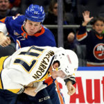 
              New York Islanders left wing Matt Martin (17) and Nashville Predators right wing Michael McCarron (47) fight during the second period of an NHL hockey game, Friday, Dec. 2, 2022, in Elmont, N.Y. (AP Photo/Julia Nikhinson)
            