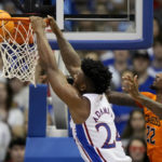 
              Kansas forward K.J. Adams Jr. (24) gets past Oklahoma State forward Kalib Boone (22) to dunk the ball during the second half of an NCAA college basketball game Saturday, Dec. 31, 2022, in Lawrence, Kan. Kansas won 69-67. (AP Photo/Charlie Riedel)
            