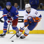 
              New York Islanders center Mathew Barzal skates with the puck as New York Rangers center Mika Zibanejad defends during the second period of an NHL hockey game Thursday, Dec. 22, 2022, in New York. (AP Photo/John Munson)
            