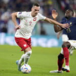 
              Poland's Arkadiusz Milik, left, and France's Youssouf Fofana, right, fight for the ball during the World Cup round of 16 soccer match between France and Poland, at the Al Thumama Stadium in Doha, Qatar, Sunday, Dec. 4, 2022. (AP Photo/Natacha Pisarenko)
            