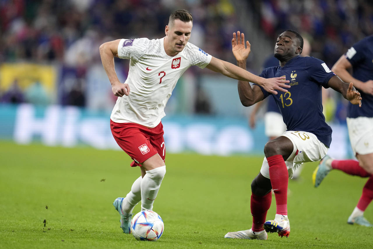 Poland's Arkadiusz Milik, left, and France's Youssouf Fofana, right, fight for the ball during the ...