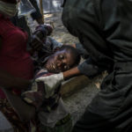 
              A youth suffering cholera symptoms is helped upon arrival at a clinic run by Doctors Without Borders in Port-au-Prince, Haiti, on Oct. 27, 2022. (AP Photo/Ramon Espinosa)
            