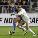 
              UCLA's Ally Cook, left, and Alabama's Riley Tanner, right, vie for control of the ball during the first half of an NCAA women's soccer tournament semifinal in Cary, N.C., Friday, Dec. 2, 2022. (AP Photo/Karl B DeBlaker)
            