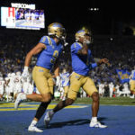 
              FILE - UCLA wide receiver Jake Bobo (9) and quarterback Dorian Thompson-Robinson (1) celebrate after a touchdown during the first half of an NCAA college football game against Stanford in Pasadena, Calif., Saturday, Oct. 29, 2022.  UCLA cleared a major hurdle toward joining the Big Ten Conference in 2024, getting approval for the move from the University of California Board of Regents on Wednesday, Dec. 14, 2022. (AP Photo/Ashley Landis, File)
            