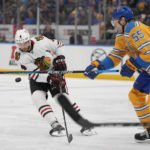 
              Chicago Blackhawks' Seth Jones (4) and St. Louis Blues' Colton Parayko (55) battle for a loose puck during the third period of an NHL hockey game Thursday, Dec. 29, 2022, in St. Louis. (AP Photo/Jeff Roberson)
            