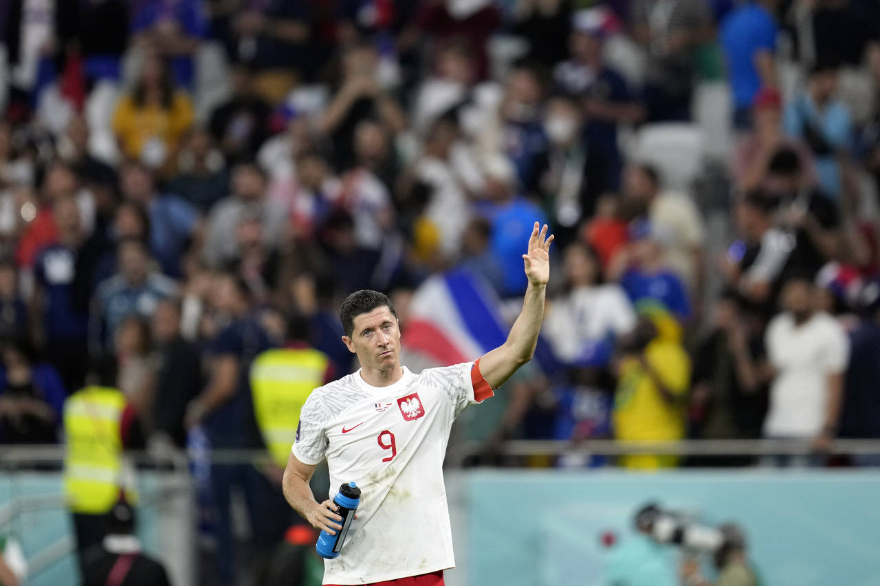 Poland's Robert Lewandowski waves after the World Cup round of 16 soccer match between France and P...