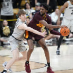 
              Arizona State forward Warren Washington, front right, passes the ball as Colorado center Lawson Lovering, left, defends in the second half of an NCAA college basketball game Thursday, Dec. 1, 2022, in Boulder, Colo. (AP Photo/David Zalubowski)
            
