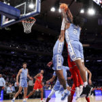 
              North Carolina guard Caleb Love (2) grabs the ball during the first half of an NCAA college basketball game against Ohio State in the CBS Sports Classic, Saturday, Dec. 17, 2022, in New York. (AP Photo/Julia Nikhinson)
            