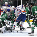
              Dallas Stars goaltender Jake Oettinger defends against pressure from Edmonton Oilers left wing Warren Foegele (37) as Miro Heiskanen (4) and Colin Miller (6) assist on the play in the second period of an NHL hockey game, Wednesday, Dec. 21, 2022, in Dallas. (AP Photo/Tony Gutierrez)
            