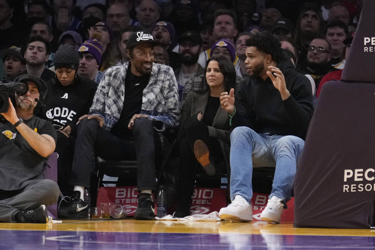 Former NBA players Miles Bridges, right, and Scottie Pippen, second from left, talk during the seco...