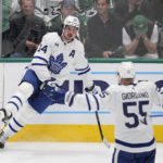 
              Toronto Maple Leafs center Auston Matthews and defenseman Mark Giordano (55) celebrate after Matthews scored in the second period of an NHL hockey game against the Dallas Stars, Tuesday, Dec. 6, 2022, in Dallas. (AP Photo/Tony Gutierrez)
            