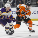 
              Los Angeles Kings forward Blake Lizotte, right, and Philadelphia Flyers forward Scott Laughton vie for the puck during the second period of an NHL hockey game Saturday, Dec. 31, 2022, in Los Angeles. (AP Photo/Ringo H.W. Chiu)
            