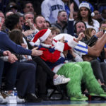 
              Kentucky forward Jacob Toppin falls onto fans during the second half of an NCAA college basketball game against UCLA in the CBS Sports Classic, Saturday, Dec. 17, 2022, in New York. The Bruins won 63-53. (AP Photo/Julia Nikhinson)
            