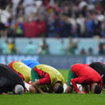 
              Players of Morococo kneel after their 0-2 lost against France in a World Cup semifinal soccer match at the Al Bayt Stadium in Al Khor, Qatar, Thursday, Dec. 15, 2022. Morocco lost 0-2. (AP Photo/Natacha Pisarenko)
            