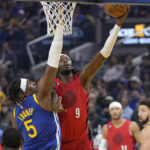 
              Portland Trail Blazers forward Jerami Grant (9) shoots against Golden State Warriors forward Kevon Looney (5) during the first half of an NBA basketball game in San Francisco, Friday, Dec. 30, 2022. (AP Photo/Jeff Chiu)
            