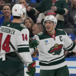 
              Minnesota Wild's Jared Spurgeon is congratulated by Joel Eriksson Ek (14) after scoring during the third period of an NHL hockey game against the St. Louis Blues Saturday, Dec. 31, 2022, in St. Louis. (AP Photo/Jeff Roberson)
            