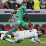 
              England's Declan Rice, right, challenges for the ball with Senegal's Pape Gueye during the World Cup round of 16 soccer match between England and Senegal, at the Al Bayt Stadium in Al Khor, Qatar, Sunday, Dec. 4, 2022. (AP Photo/Hassan Ammar)
            