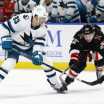 
              San Jose Sharks left wing Matt Nieto (83) is stick checked by Buffalo Sabres right wing Jack Quinn (22) during the second period of an NHL hockey game, Sunday, Dec. 4, 2022, in Buffalo, N.Y. (AP Photo/Jeffrey T. Barnes)
            