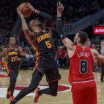 
              Atlanta Hawks guard Dejounte Murray (5) attempts to make a basket against Chicago Bulls guard Zach LaVine (8), right, during the second half of an NBA basketball game on Wednesday, Dec. 21, 2022, in Atlanta. (AP Photo/Erik Rank)
            
