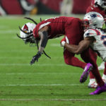 
              Arizona Cardinals wide receiver DeAndre Hopkins (10) fumbles the ball while tackled by New England Patriots safety Kyle Dugger (23) during the second half of an NFL football game, Monday, Dec. 12, 2022, in Glendale, Ariz. (AP Photo/Ross D. Franklin)
            