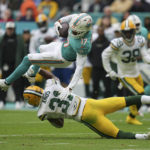 
              Miami Dolphins wide receiver Jaylen Waddle (17) gets tackled by Green Bay Packers safety Adrian Amos (31) during the first half of an NFL football game, Sunday, Dec. 25, 2022, in Miami Gardens, Fla. (AP Photo/Jim Rassol)
            
