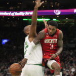 
              Houston Rockets guard Kevin Porter Jr. (3) passes the ball behind the back of Boston Celtics center Al Horford during the second half of an NBA basketball game, Tuesday, Dec. 27, 2022, in Boston. (AP Photo/Charles Krupa)
            