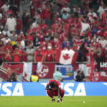 
              Canada forward Alphonso Davies reacts after a loss to Morocco in a group F World Cup soccer match at the Al Thumama Stadium in Doha, Qatar on Thursday, Dec. 1, 2022. (Nathan Denette/The Canadian Press via AP)
            