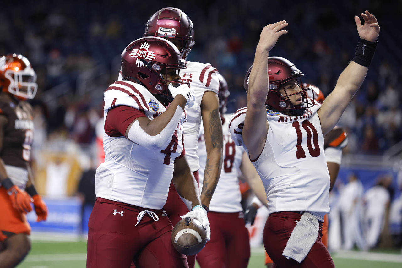 New Mexico State running back Star Thomas, left, and quarterback Diego Pavia (10) celebrate after T...