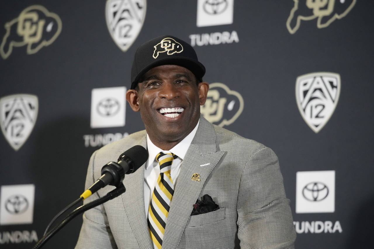 Deion Sanders speaks after being introduced as the new head football coach at the University of Col...