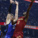 
              Cleveland Cavaliers guard Caris LeVert (3) shoots against Orlando Magic center Moritz Wagner (21) during the first half of an NBA basketball game Friday, Dec. 2, 2022, in Cleveland. (AP Photo/Ron Schwane)
            