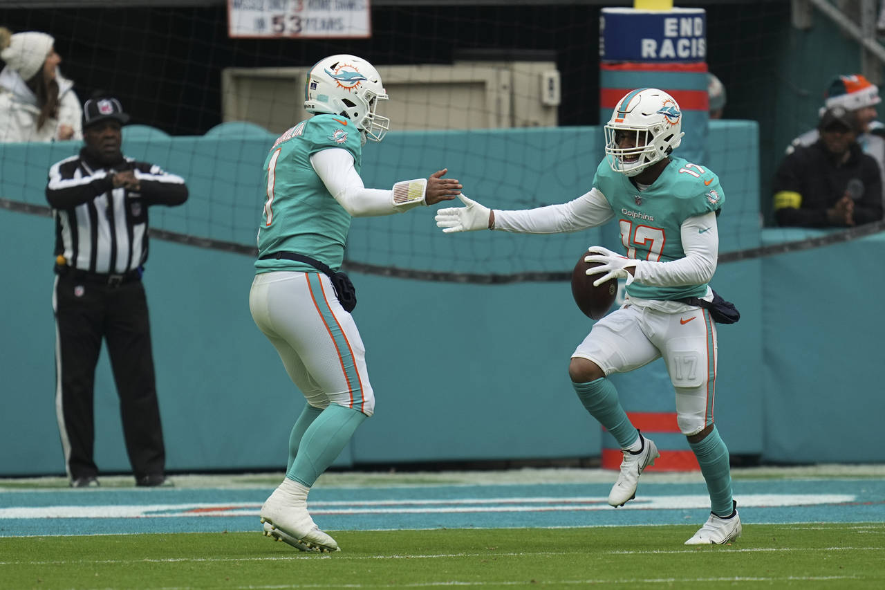 Miami Dolphins wide receiver Jaylen Waddle (17), right, celebrates with Miami Dolphins quarterback ...