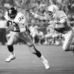 
              FILE - Pittsburgh Steelers running back Franco Harris (32) picks up 10 yards as he turns the corner as Houston Oilers' Robert Brazile (52) tries to make a dive to latch on to Harris to make the stop, during an NFL football game in Houston on Dec. 3, 1978. Harris died on Wednesday morning, Dec. 21, 2022, at age 72, just two days before the 50th anniversary of The Immaculate Reception. (AP Photo/Ed Kolenovsky, File)
            