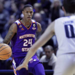 
              Hansel Enmanuel (24), a freshman guard from the Dominican Republic for Northwestern State, looks to drive around Rice guard Jaden Geron (0) during an NCAA college basketball game Saturday, Dec. 17, 2022, in Houston. Enmanuel lost his left arm in a childhood accident and has attained the talent and skill to play at the college level. (AP Photo/Michael Wyke)
            