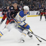 
              Buffalo Sabres' Tage Thompson, right, keeps the puck away from Columbus Blue Jackets' Gavin Bayreuther during the third period of an NHL hockey game Wednesday, Dec. 7, 2022, in Columbus, Ohio. (AP Photo/Jay LaPrete)
            