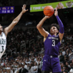 
              Northwestern's Ty Berry, right, shoots against Michigan State's Jaden Akins during the first half of an NCAA college basketball game, Sunday, Dec. 4, 2022, in East Lansing, Mich. (AP Photo/Al Goldis)
            