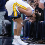 
              Golden State Warriors guard Stephen Curry (30) grabs his shoulder after after an injury during the second half of an NBA basketball game against the Indiana Pacers in Indianapolis, Wednesday, Dec. 14, 2022. The Pacers defeated the Warriors 125-119. (AP Photo/Michael Conroy)
            