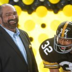 
              FILE - Former Pittsburgh Steelers running back Franco Harris stands next a statute of himself on Sept. 12, 2019, at Pittsburgh International Airport near Pittsburgh. Harris died on Wednesday morning, Dec. 21, 2022, at age 72, just two days before the 50th anniversary of The Immaculate Reception. (Nate Guidry/Pittsburgh Post-Gazette via AP, File)
            